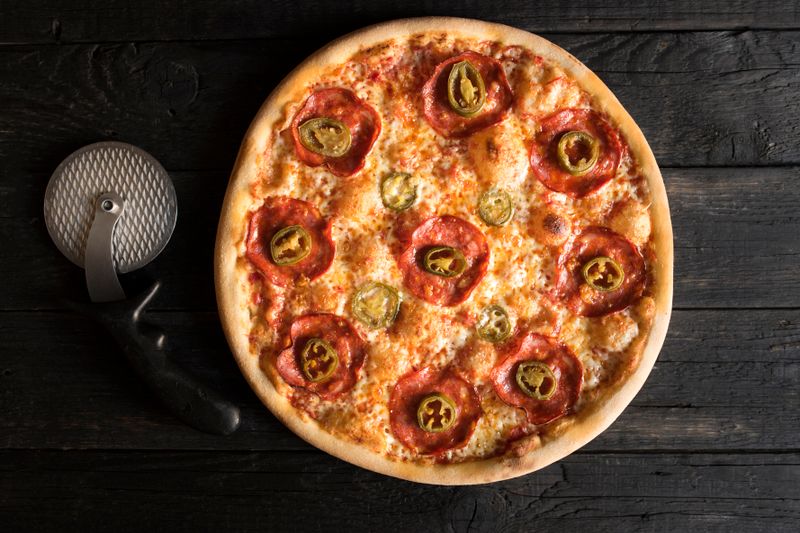 Dewey's artisan pizza with roasted peppers and sausage